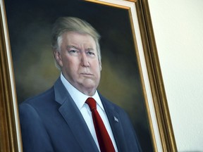 President Donald Trump's portrait hangs in the Colorado Capitol after an unveiling ceremony, Aug. 1, 2019, in Denver.