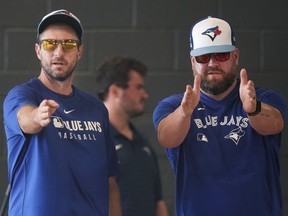 Toronto Blue Jays pitcher Max Scherzer lines up on the mound with manager John Schneider.