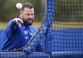 Toronto Blue Jays manager John Schneider throws at batting practice during spring training in Dunedin Fla., on Thursday, February 20, 2025. THE CANADIAN PRESS/Nathan Denette