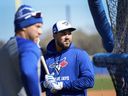 Toronto Blue Jays outfielder Anthony Santander, right, waits to hit at batting practice during spring training in Dunedin, Fla., on Friday, Feb. 21, 2025.