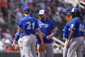 Toronto Blue Jays manager John Schneider pulls pitcher Josh Walker (21) in the fifth inning of a spring training baseball game against the Atlanta Braves in North Port, Fla., Saturday, March 1, 2025. (AP Photo/Gerald Herbert)