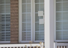 York Region Police mark what appear to be bullet holes at a home in Markham after a 20-year-old woman was killed and her 26-year-old bother was injured in what police said was a targeted shooting on Friday morning, March 7, 2025.