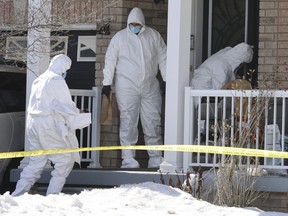 Three York Regional Police forensic investigators enter a home in Markham after a 20-year-old woman was killed and her 26-year-old bother was injured in what police said was a targeted shooting on Friday morning, March 7, 2025.