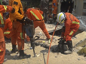 Rescue workers work in Uhla Thein Buddhist temple