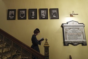 A tour guide at New Zealand's parliament gives a spooky tour of the historical Parliament library, built in 1883 and rumoured to be haunted, in Wellington. (AP Photo/Charlotte Graham-McLay)