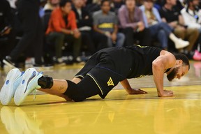 Golden State Warriors' Stephen Curry (30) grimaces in pain after landing on his back during a play in the third quarter of their NBA game at Chase Center in San Francisco, Calif., on Thursday, March 19, 2025. (Jose Carlos Fajardo/Bay Area News Group via AP)