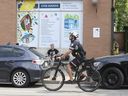 A Toronto Police bike patrol cruises by the South Riverdale Community health centre and safe injection site in Toronto on Friday, July 14, 2023.