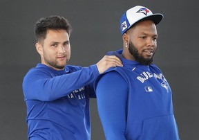 Blue Jays shortstop Bo Bichette, left, jokes around with Blue Jays first baseman Vladimir Guerrero Jr.