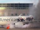 This image courtesy of Branden Williams shows passengers standing on the wing of an American Airlines plane as they are evacuated after it caught fire while at a gate at Denver International Airport in Denver, Colorado, March 13, 2025.