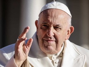 Pope Francis waves as he arrives on his popemobile to lead his weekly audience in St. Peter's Square at the Vatican, on Wednesday, March 29, 2023.