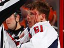 Steven Oleksy of the Washington Capitals looks up bleeding as officials break up a fight with Jakub Voracek of the Philadelphia Flyers in 2013.