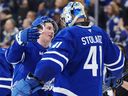 Toronto Maple Leafs' Mitch Marner (left) and goalkeeper Anthony Stolarz celebrated after defeating the Florida Panthers in Toronto on April 2, 2025. The result was that the Maple Leafs won the playoff berth.