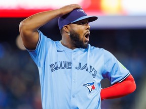 Vladimir Guerrero Jr. of the Toronto Blue Jays reacts as a foul ball flies into the stands.