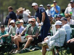Nick Taylor of Canada chips from the rough on the 18th hole during the second round of the 2025 Masters Tournament.