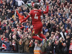 Liverpool's Virgil van Dijk celebrates after scoring his side's second goal against West Ham United.