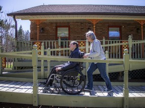 Sandy Tucker pushes her son, Benjamin Firth, who is in a wheelchair.