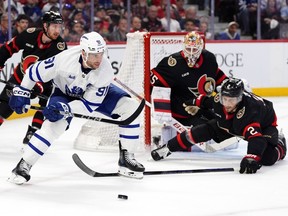 Toronto Maple Leafs' John Tavares (91) skates over the stick of Ottawa Senators' Artem Zub in front of goaltender Linus Ullmark during Game 3.