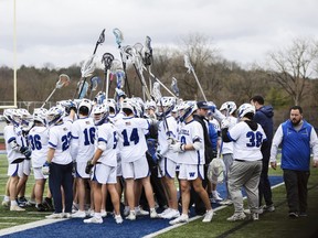 The Westhill boys lacrosse team huddles up during a matchup against General Brown at Westhill High School.