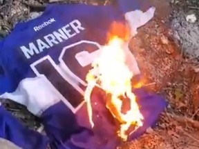 A Toronto Maple Leafs fan burns a Mitch Marner jersey.