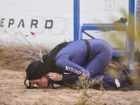 This handout photo from Blue Origin shows U.S. singer Katy Perry kissing the ground upon return to Earth after a flight on Blue Origin New Shepard NS-31, in Van Horn, West Texas, April 14, 2025.