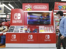 A man walks by a Nintendo Switch display