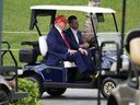 President Donald Trump, driven by his son Eric Trump, arrives at Trump National during the LIV Golf Miami Championships in Miami on Thursday, April 3, 2025.
