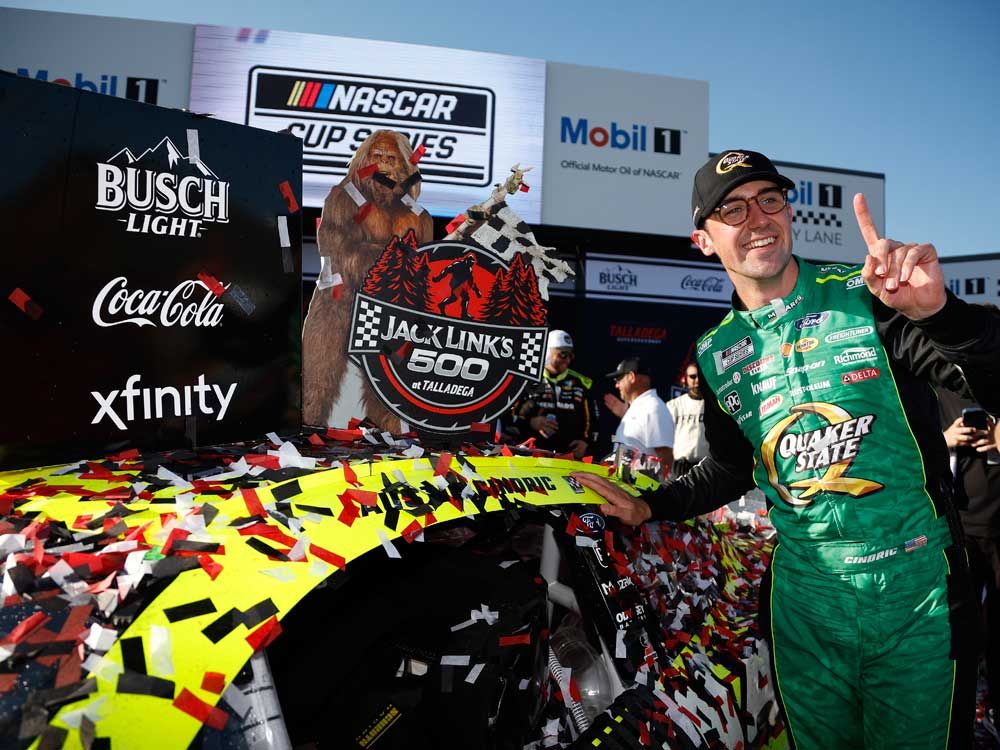 Austin Cindric, driver of the #2 Menards/Quaker State Ford, poses with the winner sticker on his car in victory lane after winning the NASCAR Cup Series Jack Link's 500 at Talladega Superspeedway on April 27, 2025 in Talladega, Alabama.