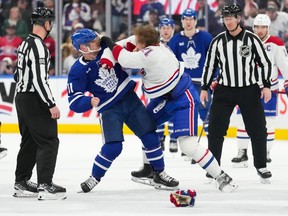 Kaiden Guhle of Canadaens (right) and Maple Leafs’ Max Domi (left) fight in the second phase of NHL action, Toronto, Saturday, April 12, 2025.