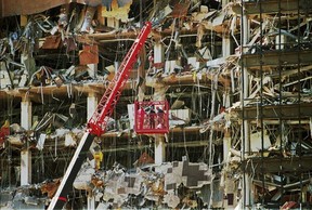 Rescue workers dig through the rubble from the Alfred P. Murrah Federal Building explosion in downtown Oklahoma City on April 20, 1995. (AP Photo/J.Pat Carter, File)