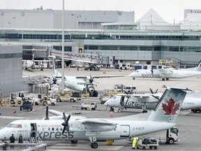 Planes sit on the tarmac at Toronto Pearson Airport’s Terminal 1 March 13, 2020.