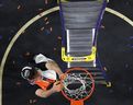 Florida Gators Olivier Rioux cuts the net at the Alamodome on Monday in San Antonio, Texas. Getty Images