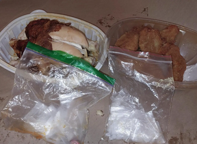 An image from Kingston Police of a rotisserie chicken stuffed with illicit drugs.