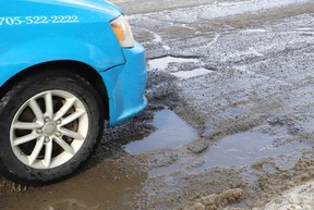 Potholes on College Street near Frood Road in Sudbury, Ont. on Monday March 10, 2025. John Lappa/Postmedia Network