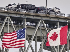 A truck with vehicles crosses the Blue Water Bridge