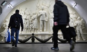 Commuters pause walking past the newly unveiled high relief depicting Soviet dictator Joseph Stalin in a passage at Taganskaya metro station in Moscow on May 15, 2025. ALEXANDER NEMENOV/AFP via Getty Images)