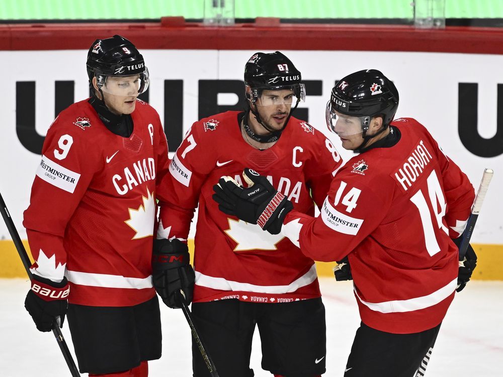Canada's Sidney Crosby (center) celebrates after scoring a goal with teammates Nate MacKinnon (left) and Bo Horvat during the IIHF World Championship Group A match between Canada and France at Avicii Arena in Stockholm, Sweden, Tuesday, May 13, 2025. 