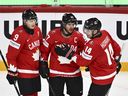 Canada's Sidney Crosby (center) celebrates after scoring a goal with teammates Nate MacKinnon (left) and Bo Horvat during the IIHF World Championship Group A match between Canada and France at Avicii Arena in Stockholm, Sweden, Tuesday, May 13, 2025.