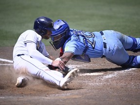 Tampa Bay Rays' Brandon Lowe beats the tag at home.