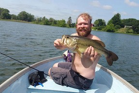 This undated image shows Chris Pelkey with a fish at Crystal Lake in Coram, N.Y.
