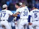 Blue Jays' Ernie Clement, centre, celebrates after hitting a walk-off RBI single to win the game in the bottom of the ninth inning against the Tigers at Rogers Centre in Toronto, Saturday, May 17, 2025.
