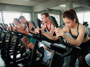 People on spin bikes in gym.