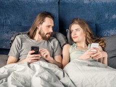 Couple in bed with smartphones