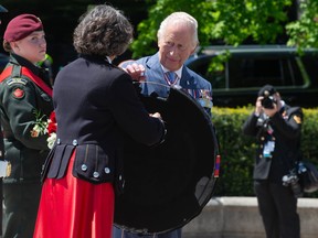 King Charles III prepares to place a wreath at the Tomb of the Unknown Soldier at the National War Monument in Ottawa on Tuesday