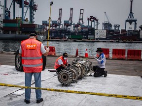 Indonesian investigators inspect the wreckage of an engine from Lion Air Flight JT 610 recovered from the sea at the Tanjung Priok port on Nov. 4, 2018 in Jakarta, Indonesia. All 189 passengers and crew for the Boeing 737 plane died in the crash into the Java sea shortly after takeoff.