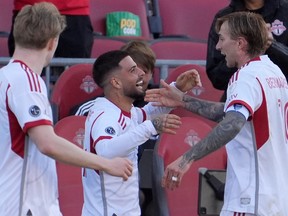 Toronto FC forward Lorenzo Insigne (centre) celebrates his goal against D.C. United with teammate Federico Bernardeschi (right) during second half MLS action in Toronto, Saturday, May 10, 2025.