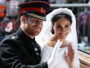 Prince Harry, Duke of Sussex, and his wife Meghan, Duchess of Sussex, wave from Ascot Landau's carriage as they head back to Windsor Castle in Windsor, England, after their wedding ceremony on May 19, 2018.