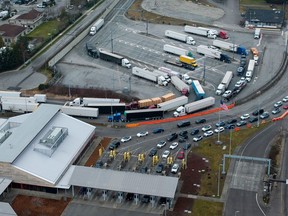 Tractor trailers entering the U.S. from Canada at the Pacific Highway Border Crossing in Blaine, Wash., March 3, 2025.