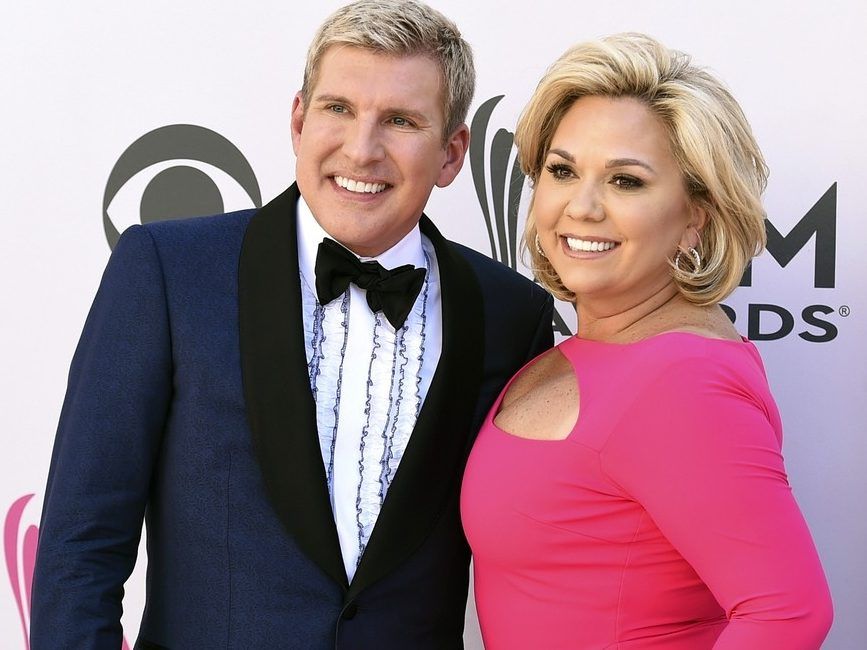 Julie Chrisley, right, and her husband Todd Chrisley pose for photos at the 52nd annual Academy of Country Music Awards on April 2, 2017, in Las Vegas.