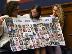 Women hold a banner with pictures of victims of one of the Boeing Max 8 crashes at a hearing where Captain Chesley B. "Sully" Sullenberger III testified at the Rayburn House Building on June 19, 2019, in Washington, D.C. MUST CREDIT: Katherine Frey/The Washington Post