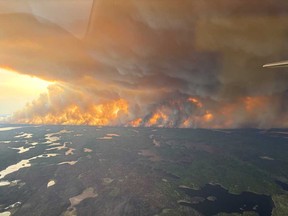 This May 27, 2025, aerial image courtesy of the Manitoba Government, shows wildfires burning in Flin Flon, Man.